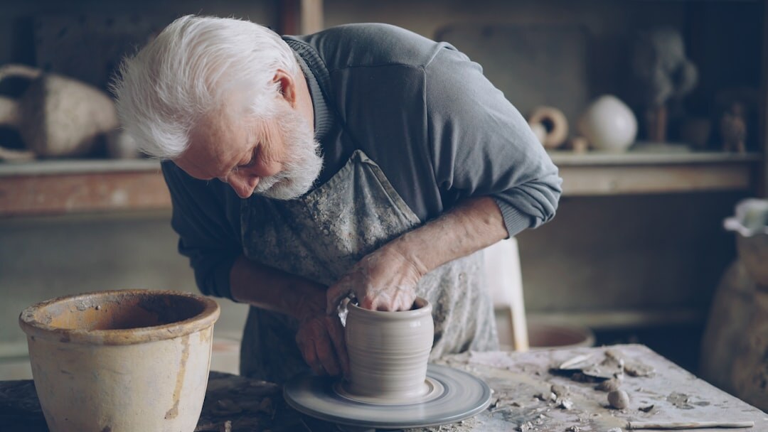 Elderly people doing a pottery and craft workshop together