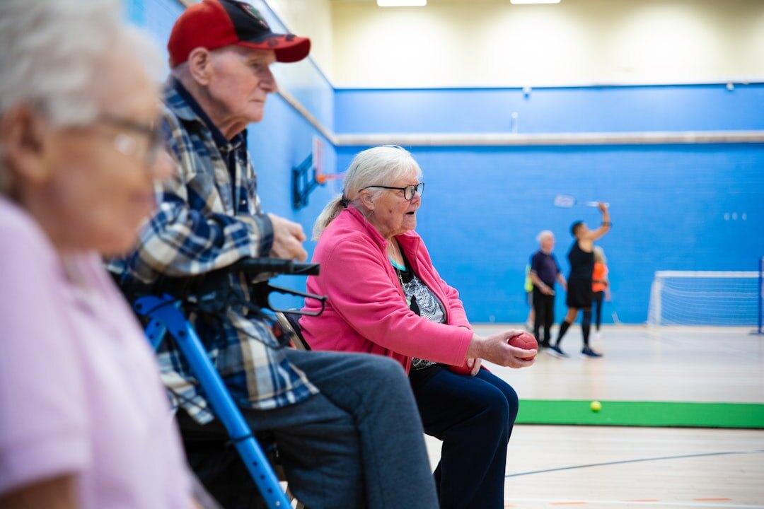 Group of elderly people dancing together in a community hall