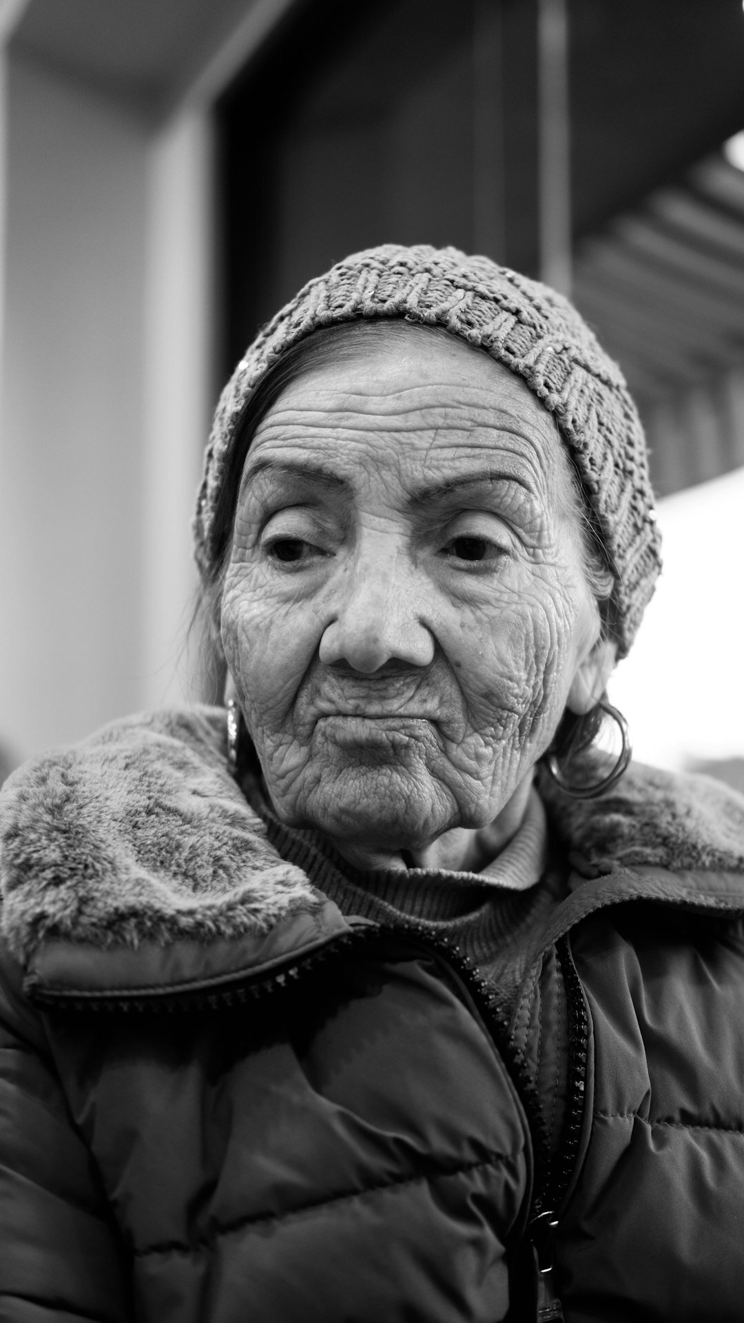 Smiling senior Slovak woman giving thumbs up in a cozy sweater